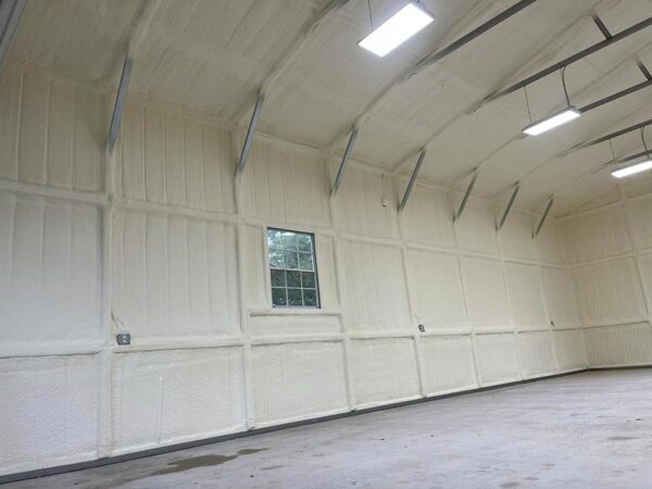 Closed-cell spray foam insulation on metal building roof trusses and wall panels in Montgomery, TX