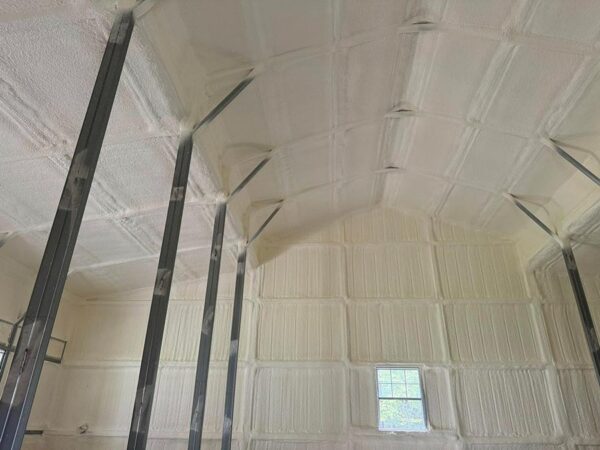 Closed-cell spray foam insulation on barndominium roof trusses and purlins in Cleveland, TX