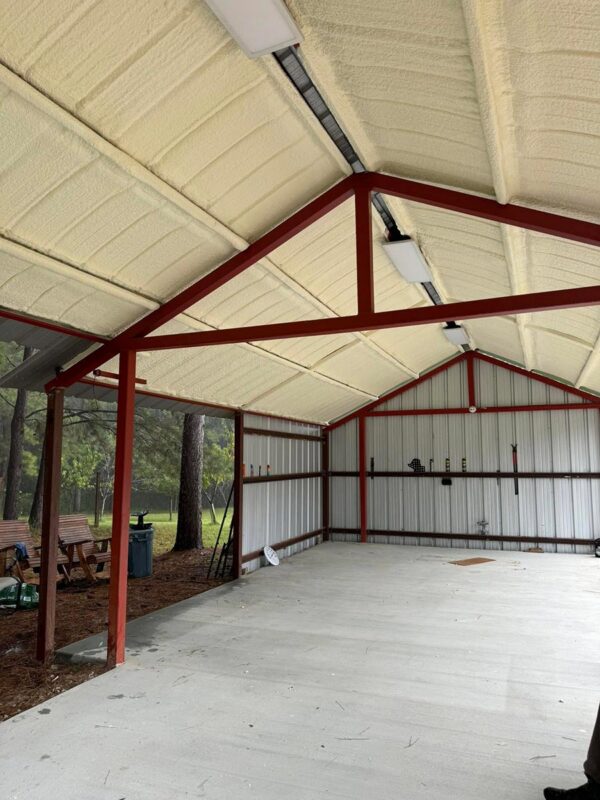 Closed-cell spray foam insulation on a steel-frame open bay structure roof, Coldspring, TX