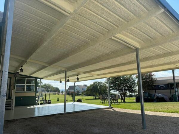 Closed-cell spray foam insulation on the underside of an attached patio cover roof in Crosby, TX
