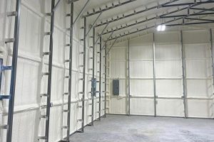 Closed-cell spray foam insulation applied inside a metal building in North Houston TX