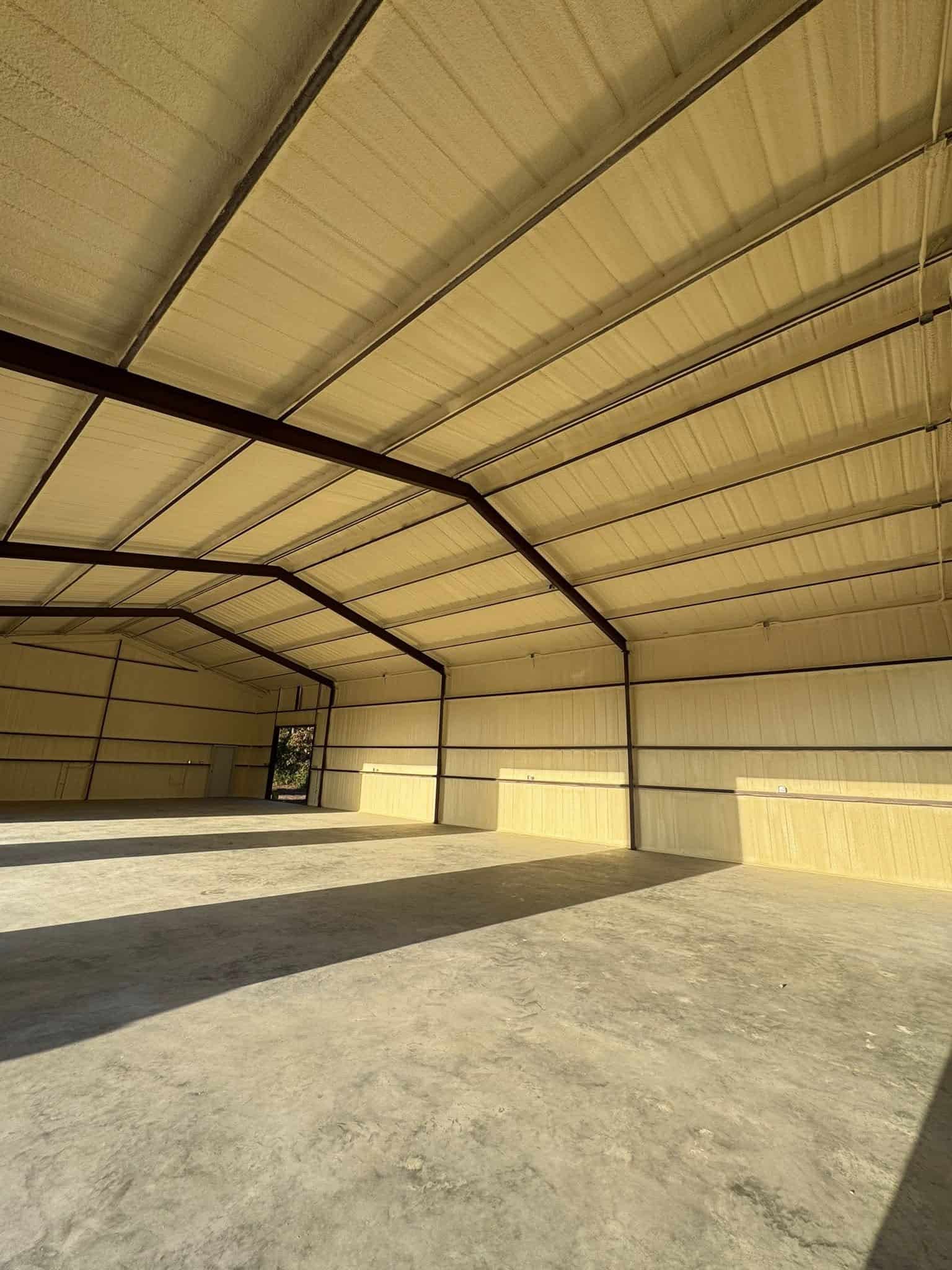 Closed-cell spray foam insulation applied to the interior roof of a metal building in Trinity TX